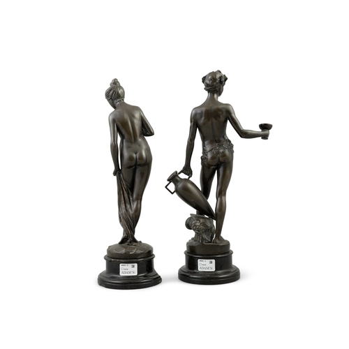 621 - A PAIR OF CAST BRONZE FIGURES  of Venus and Bacchus, raised on stepped black marble bases (1 damaged... 