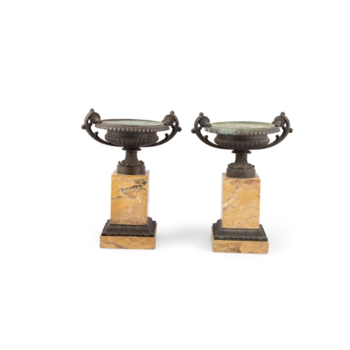 626 - A PAIR OF BRONZE CAMPAGNA URNS ON SIENNA MARBLE PLINTH BASES. 33cm high, 27cm wide, 20cm diameter