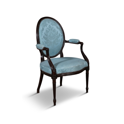 640 - A GEORGE III WALNUT UPHOLSTERED FAUTEUIL,   with oval padded back and seat covered in a light blue d... 