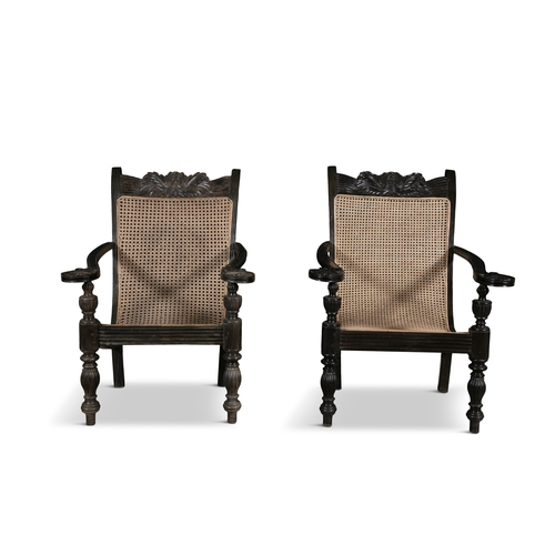 641 - A PAIR OF ANGLO INDIAN ARMCHAIRS 19TH CENTURY   scroll back reeded frame with cane back and seat lea... 