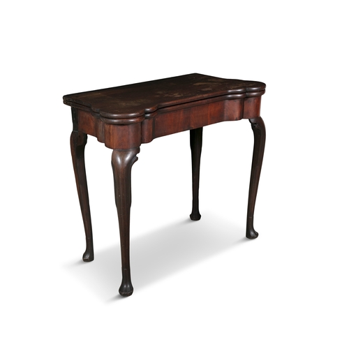 653 - AN IRISH GEORGE III MAHOGANY FOLDING TOP CARD TABLE,   of rectangular shape with outset rounded corn... 