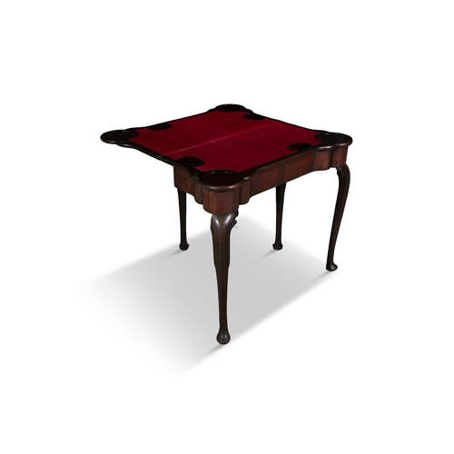 653 - AN IRISH GEORGE III MAHOGANY FOLDING TOP CARD TABLE,   of rectangular shape with outset rounded corn... 