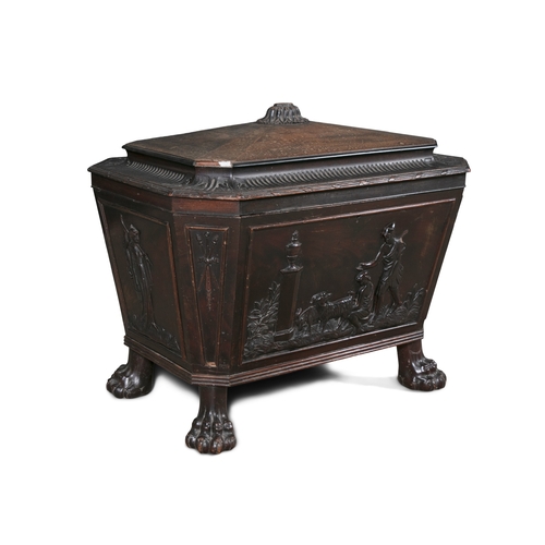 660 - A GEORGE IV MAHOGANY CELLERETTE  of sarcophagus form, the lid surmounted with carved flower head and... 