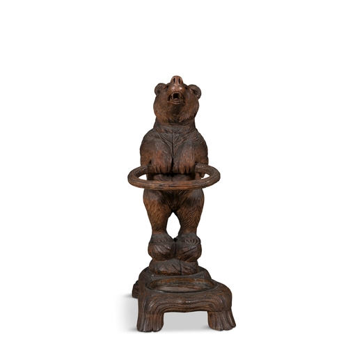 677 - A SWISS CARVED LINDEN WOOD BEAR-CUB STICK STAND, LATE 19TH CENTURY   Black Forest, 87cm high.  Prove... 