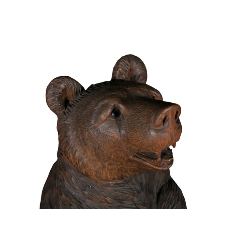 677 - A SWISS CARVED LINDEN WOOD BEAR-CUB STICK STAND, LATE 19TH CENTURY   Black Forest, 87cm high.  Prove... 