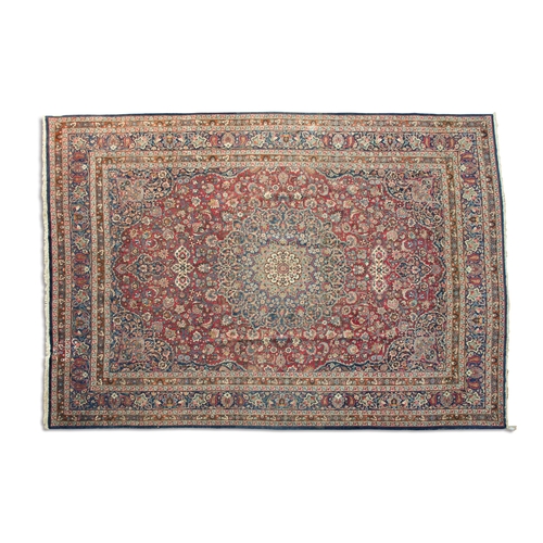 688 - A LARGE PERSIAN RED AND NAVY GROUND CARPET, 410 X 305CM the rectangular field woven with a central r... 