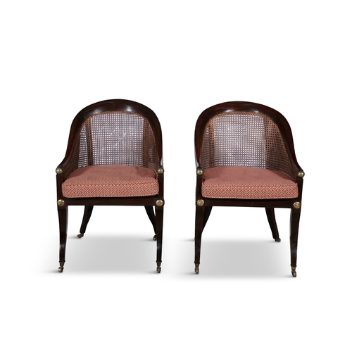 701A - A PAIR OF REGENCY STYLE MAHOGANY TUB BACK LIBRARY CHAIRS 19TH CENTURY  with cane backs and seat, bra... 