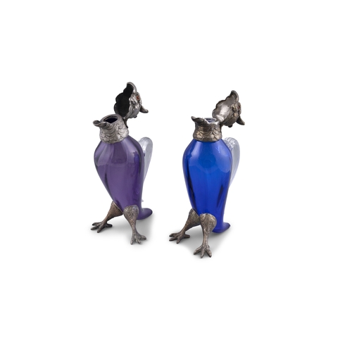 718 - A PAIR OF CONTINENTAL PURPLE AND BLUE GLASS DECANTERS IN THE FORM OF PARROTS,  with silver plated hi... 