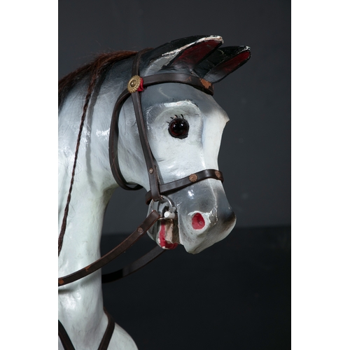 727 - AN EDWARDIAN PAINTED TIMBER ROCKING HORSE,   painted in white and grey tones, with saddle and stirru... 