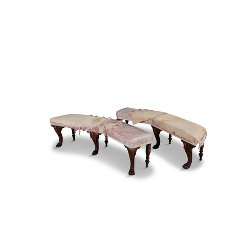 735 - A PAIR OF IRISH CARVED MAHOGANY WINDOW SEATS,  of curved form, each raised on six legs, the front th... 