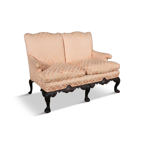 121 - AN IRISH CARVED MAHOGANY FRAMED TWO-SEATER SETTEE 19TH CENTURY,  with two loose cushions, the back s... 