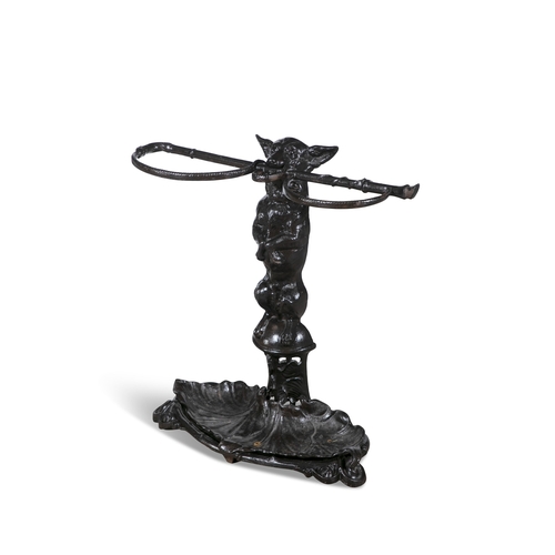 13 - A VICTORIAN BLACK PAINTED CAST IRON STICK STAND,   in the form of an upright hound, holding a riding... 