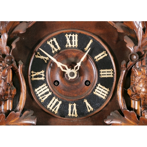 147 - A CARVED 'BLACK FOREST' LINDEN WOOD CUCKOO CLOCK, EARLY 20TH CENTURY   in the form of a bird house c... 