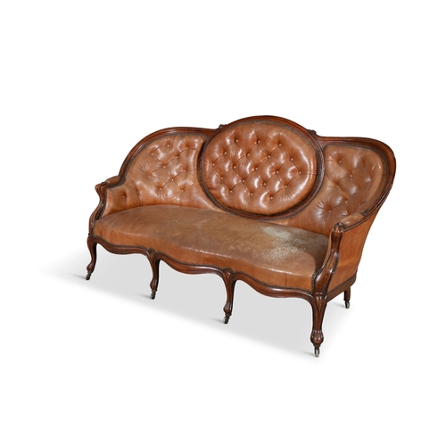 205 - A VICTORIAN WALNUT FRAMED HUMP BACK THREE-SEATER SETTEE,  the button back and padded seat upholstere... 