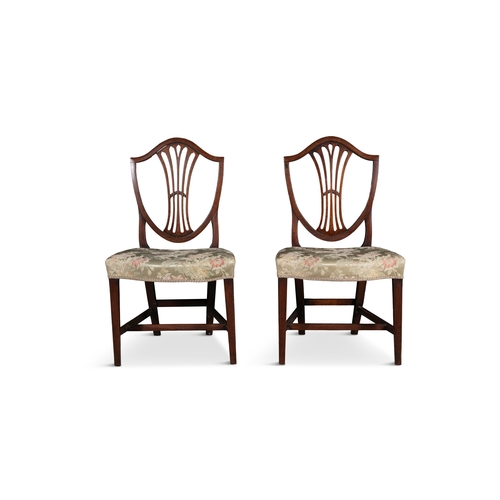 213 - A SET OF EIGHT GEORGIAN MAHOGANY FRAMED SHERATON DINING CHAIRS,  each with shield backs, above serpe... 