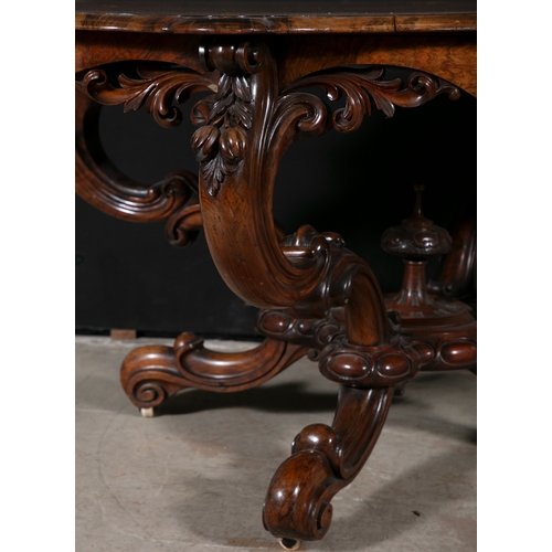 217 - A VICTORIAN WALNUT SHAPED OVAL CENTRE TABLE,  the shaped frieze with pierced carved acanthus leaf de... 