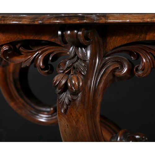 217 - A VICTORIAN WALNUT SHAPED OVAL CENTRE TABLE,  the shaped frieze with pierced carved acanthus leaf de... 