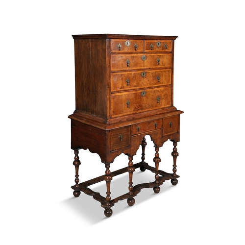 218 - A WILLIAM & MARY WALNUT CHEST ON STAND CIRCA 1700,  the rectangular upper section with moulded corni... 