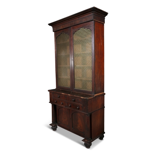 228 - A MAHOGANY TWO DOOR BOOKCASE 19TH CENTURY,  with twin brass grille doors, fitted with four shelves, ... 