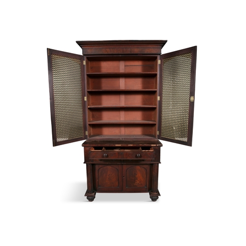 228 - A MAHOGANY TWO DOOR BOOKCASE 19TH CENTURY,  with twin brass grille doors, fitted with four shelves, ... 