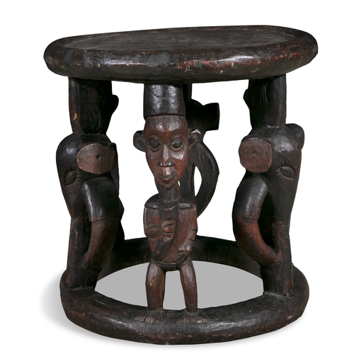 245 - A PAIR OF AFRICAN CARVED WOOD FIGURAL STOOLS,   probably Cameroon, each of circular shape with dishe... 