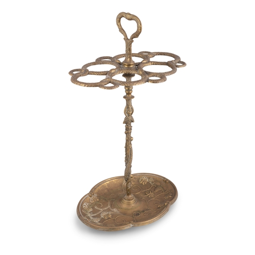 37 - A VICTORIAN BRASS UMBRELLA/STICK STAND,  with loop handle above an elaborate snake aperture, support... 