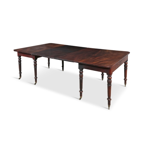 54 - AN IRISH GEORGE IV MAHOGANY EXTENDING DINING TABLE,   with two additional leaves, raised on lotus co... 