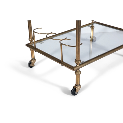 115 - DRINKS TROLLEY  A brass two tier drink’s trolley with glass tops on castors. Italy, c.1960. 68 x 41 ... 