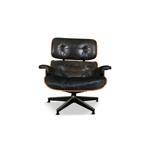 62 - LOUNGE CHAIR  A rosewood lounge chair and footstool by Charles and Ray Eames. c.1970. 85 x 83 x 85cm... 