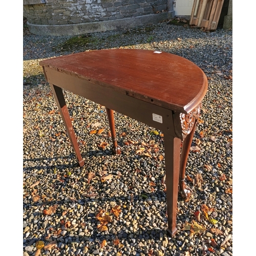 77 - A COMPOSED CARVED MAHOGANY D-SHAPED SIDE TABLE 18TH CENTURY,   with solid panel top above a masked f... 