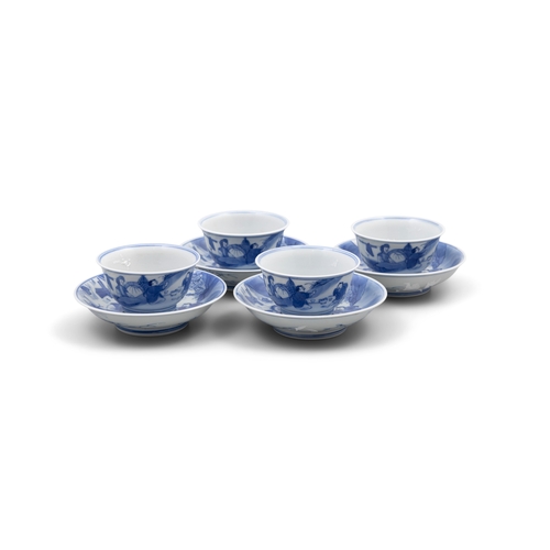 256 - A SET OF FOUR BLUE AND WHITE TEACUPS AND SAUCERS, MARK ZHEN YU TANG  清康熙 珍玉堂款 青花农家乐杯碟一组四套  depicting... 