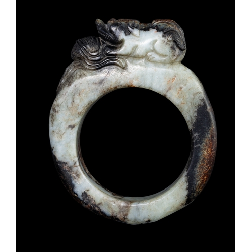 308 - A BLACK AND WHITE JADE RING WITH A PLAYING LION ON THE TOP  明早 黑白玉戏狮环   China, early Ming dynasty.  ... 