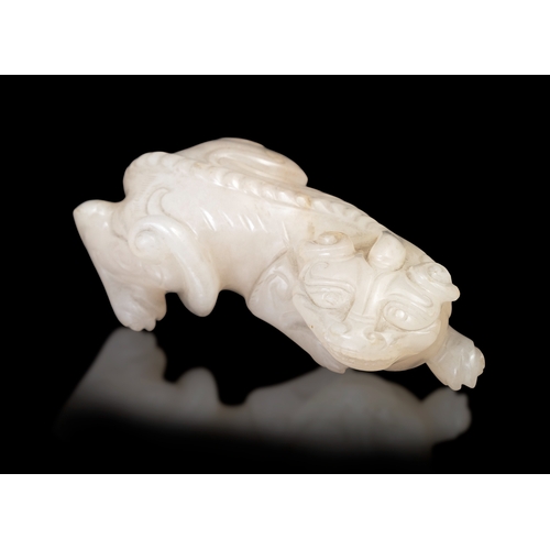 310 - A WHITE JADE CARVED LAYING BIXIE  China, Ming dynasty (1368-1644).  L. 7cm