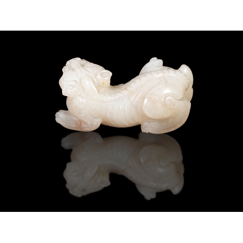 310 - A WHITE JADE CARVED LAYING BIXIE  China, Ming dynasty (1368-1644).  L. 7cm