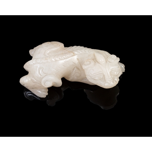 310 - A WHITE JADE CARVED LAYING BIXIE  China, Ming dynasty (1368-1644).  L. 7cm