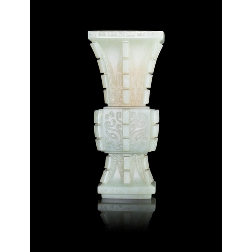 311 - AN ARCHAISTIC CELADON JADE FANG GU VASE  晚清-民国 青玉饕餮纹出戟出戟方觚  China, late Qing - Republic period  of a... 