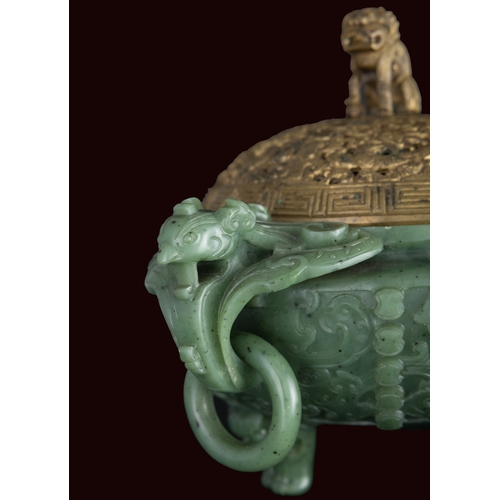 316 - A SPINACH-GREEN JADE ARCHAISTIC TRIPOD INCENSE BURNER  19世纪 碧玉仿古凤鸟纹双耳活环三足炉  China, 19th century  The... 