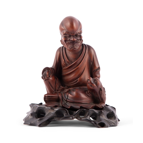 385 - A CARVED BOXWOOD FIGURE OF AN ASCETIC  清代 黃楊木羅漢  China, Qing dynasty  H.10.2cm without stand