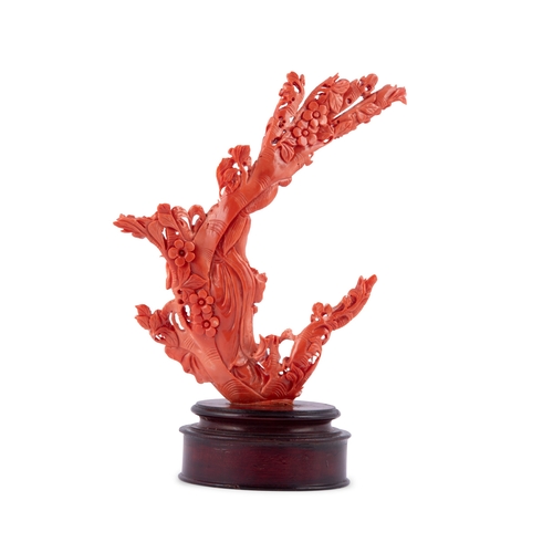 459 - *A CARVED RED CORAL GROUP OF A FEMAIL FIGURE HOLDING A BASKET OF FLOWER, WITH A WOODEN STAND  China,... 