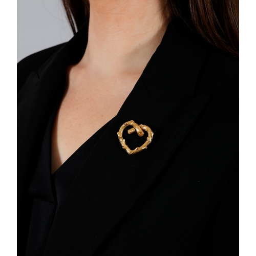 102 - VAN CLEEF & ARPELS: A GOLD BROOCH, CIRCA 1970  Of openwork design, the textured gold heart, in 18K g... 