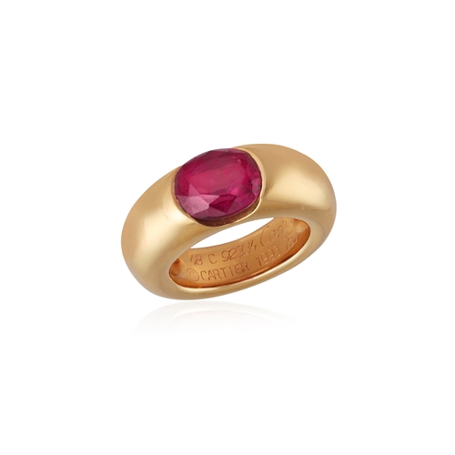 103 - CARTIER: A GARNET DRESS RING, 1993  The oval-shaped pyrope-almandite garnet weighing approximately 3... 