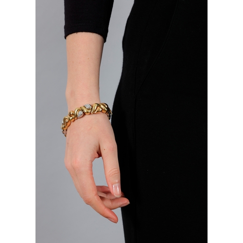 113 - AN 18K GOLD AND DIAMOND BRACELET  Of bi-coloured design, composed of alternating polished scrolled a... 