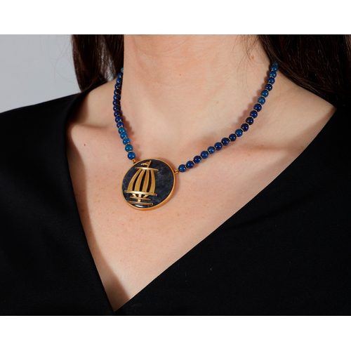 115 - LALAOUNIS: AN 18K GOLD AND SODALITE NECKLACE
The circular-shaped sodalite disc set with a motif depi... 