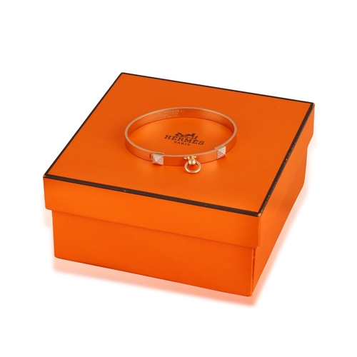 125 - HERMÈS: A DIAMOND 'COLLIER DE CHIEN' BANGLE, 2022
The oval hinged bangle highlighted with two pyrami... 