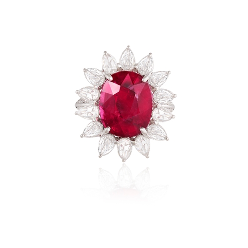 128 - A RUBELLITE AND DIAMOND DRESS RING  The cushion-shaped rubellite weighing approximately 5.70cts with... 