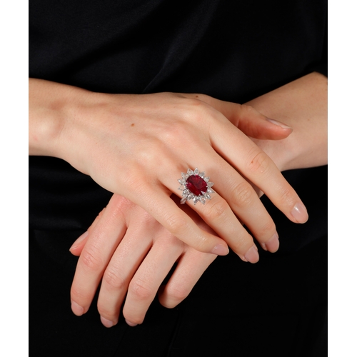 128 - A RUBELLITE AND DIAMOND DRESS RING  The cushion-shaped rubellite weighing approximately 5.70cts with... 