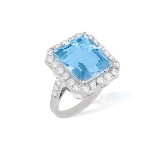 129 - AN AQUAMARINE AND DIAMOND DRESS RING  The rectangular-cut aquamarine weighing 10.56cts, within a bri... 