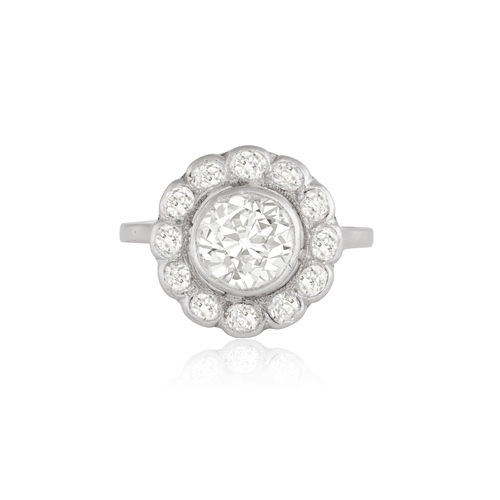 130 - AN EARLY 20TH CENTURY DIAMOND RING  Of target design, the cluster centring a European-cut diamond we... 