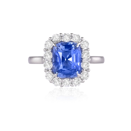 134 - A SAPPHIRE AND DIAMOND CLUSTER RING  Set with a cushion-shaped sapphire weighing 3.62cts, within a f... 