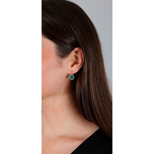 136 - A PAIR OF EMERALD AND DIAMOND EARRINGS  Each set with an oval-shaped emerald, framed by brilliant-cu... 